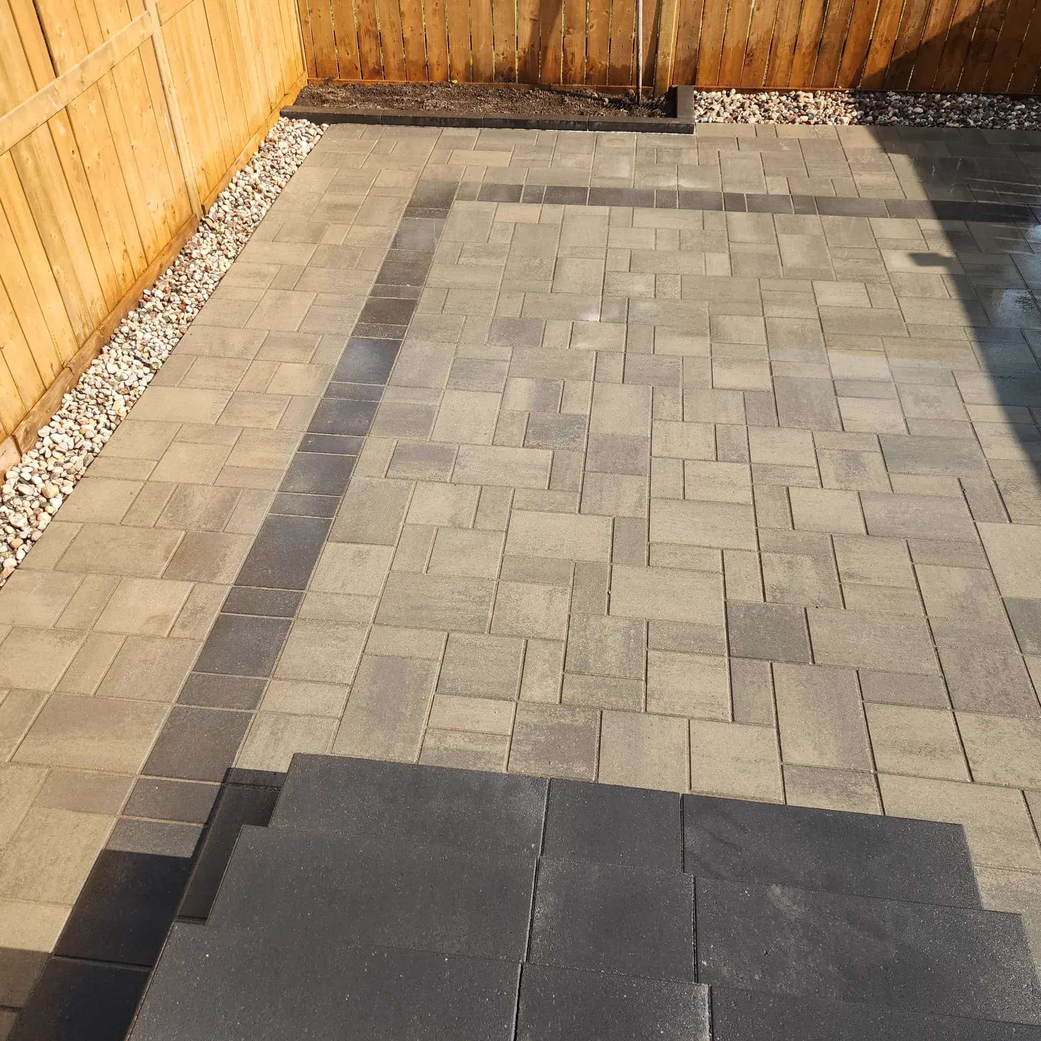 Multi-tone backyard patio with cedar-fence borders