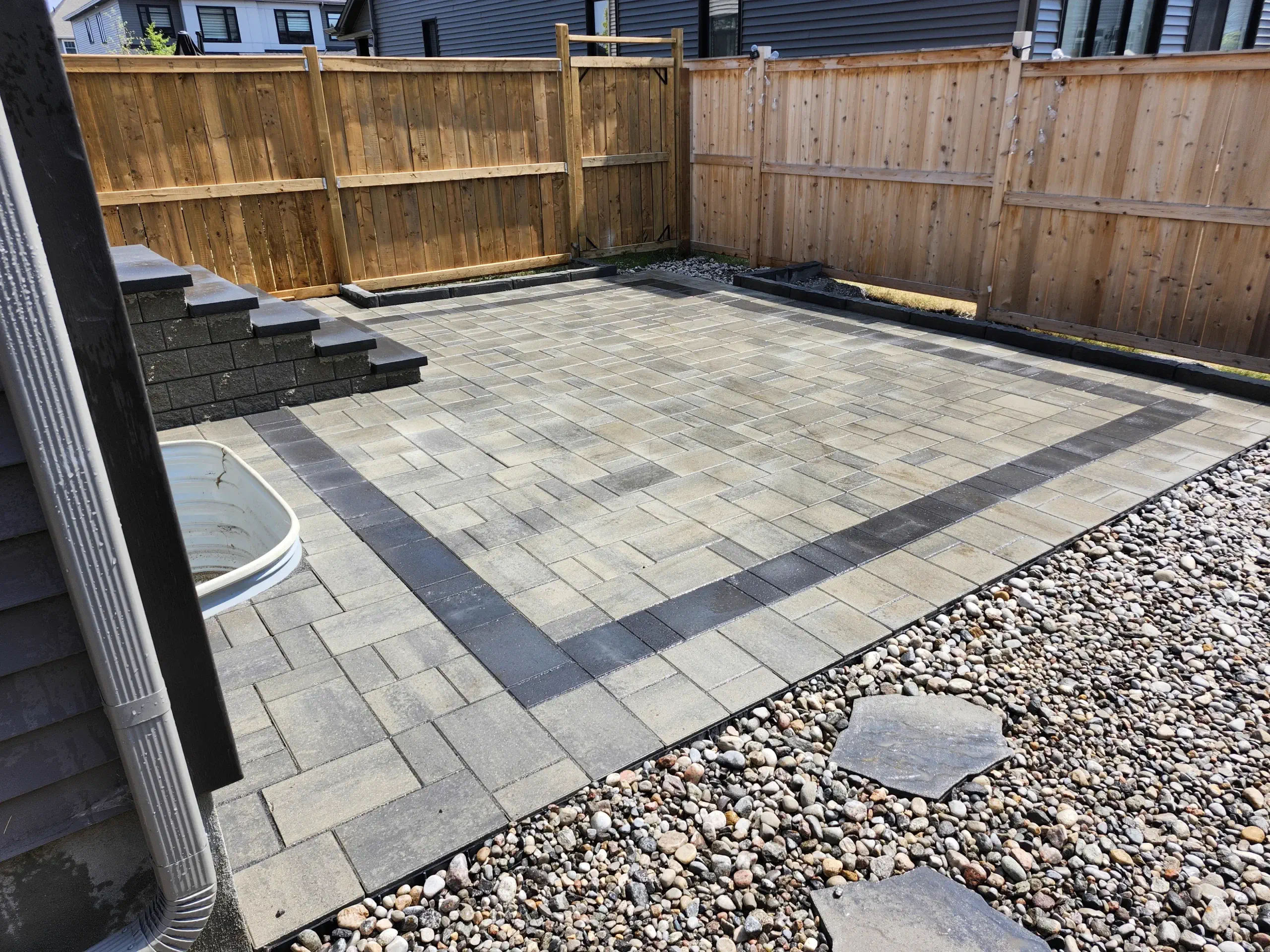 Multi-tone backyard patio with cedar-fence borders