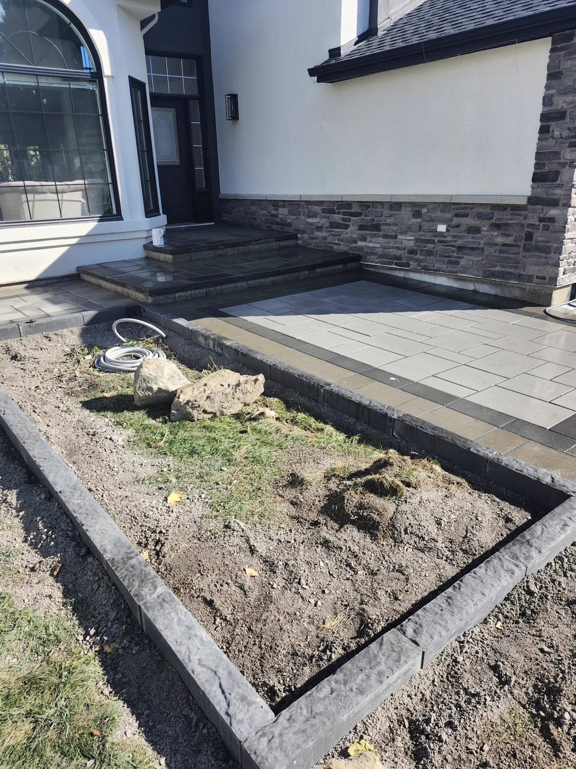Stone-veneer front entry with grey landing